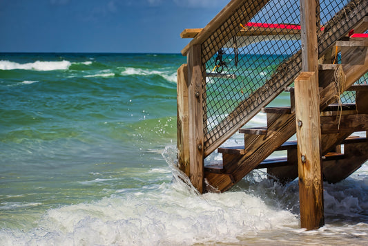brown wooden stair beside blue beach