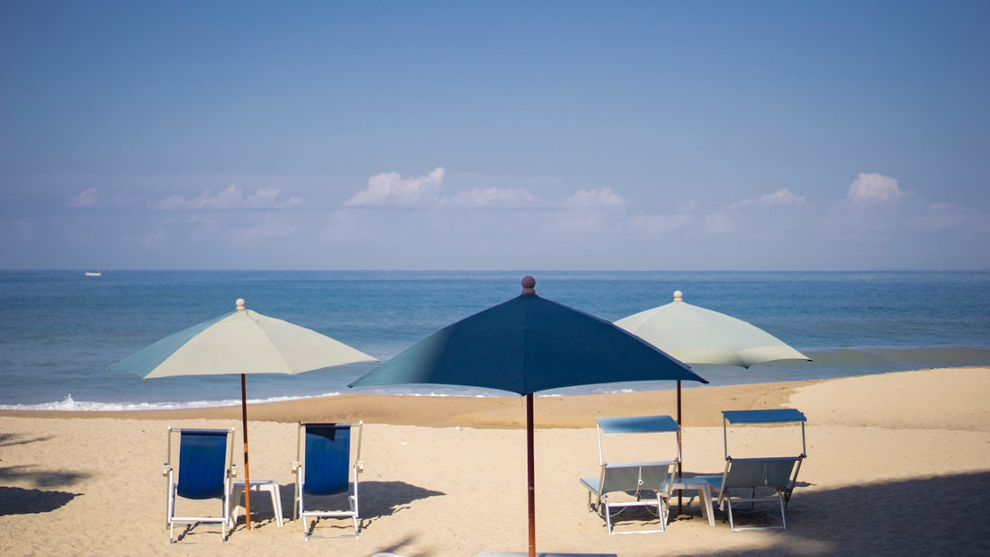 blue and white patio umbrella on beach during daytime