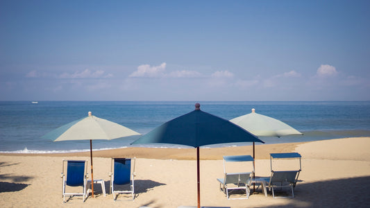 blue and white patio umbrella on beach during daytime