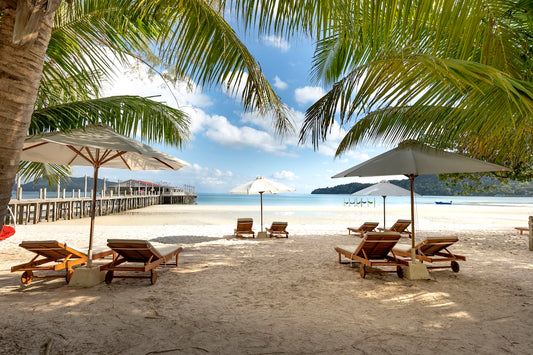 lounge chairs and umbrellas on a sandy beach