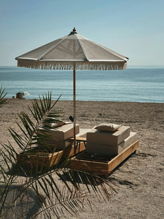 an umbrella and some boxes on a beach